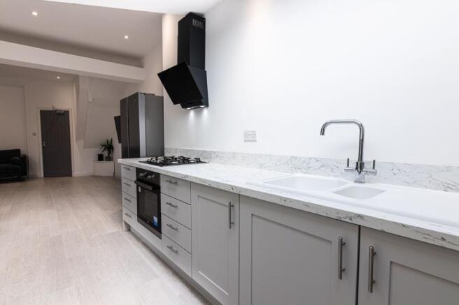 Bright modern kitchen with marble-effect workto...