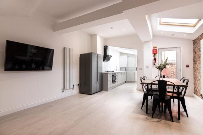 Bright, modern open-plan living and kitchen are...