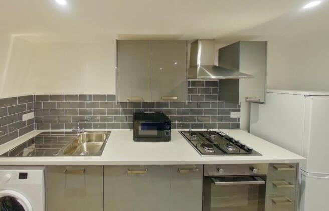 A modern and tidy kitchenette featuring sleek c...