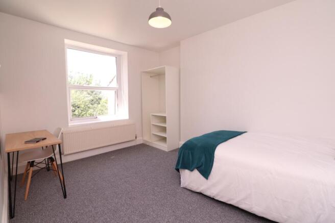 A bright and spacious double bedroom featuring ...