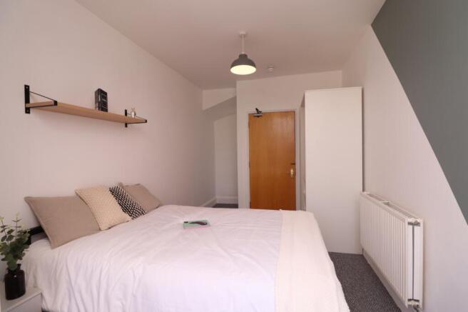 A bright and inviting double bedroom featuring ...