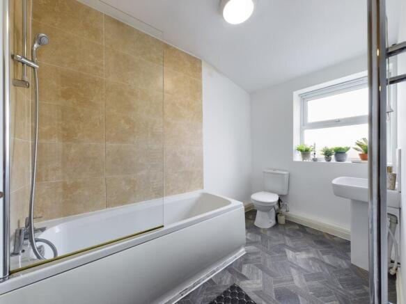 A spacious and bright bathroom featuring a mode...