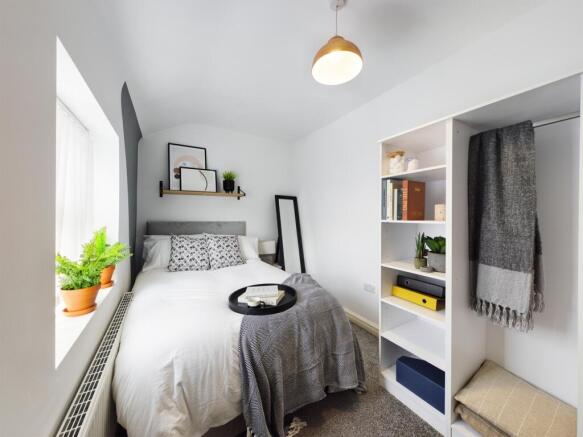 A bright and cozy double bedroom featuring styl...