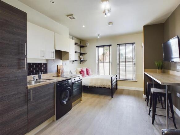 A modern and stylish kitchenette with ample spa...