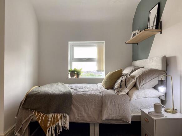 A bright and inviting double bedroom featuring ...