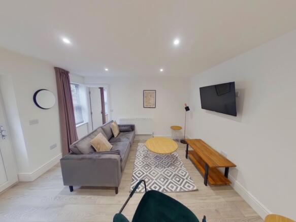 A spacious and modern living room featuring sty...