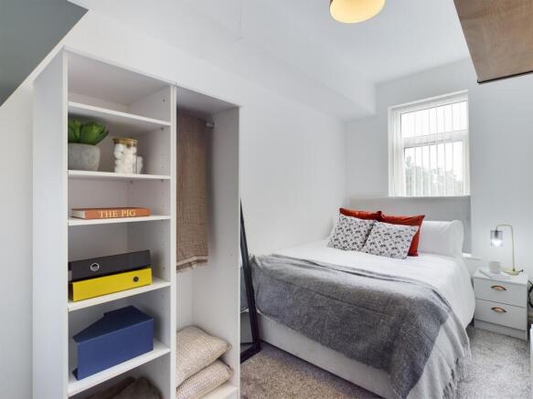 A stylish and well-organized double bedroom, fe...