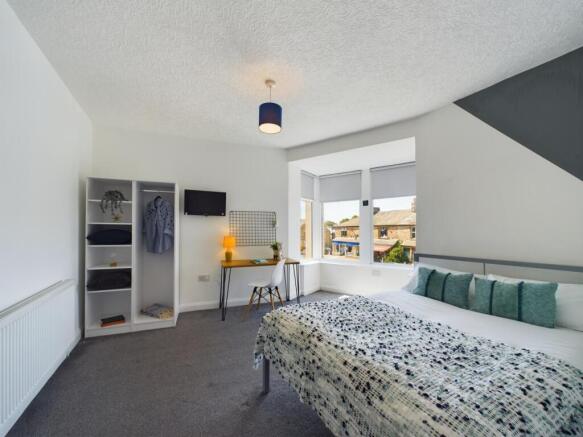 A bright and tidy living room featuring a large...