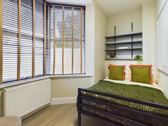 A bright and inviting double bedroom featuring ...