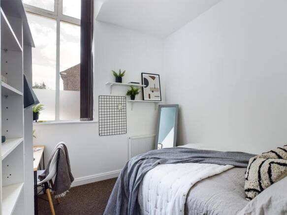 A bright and inviting double bedroom with moder...