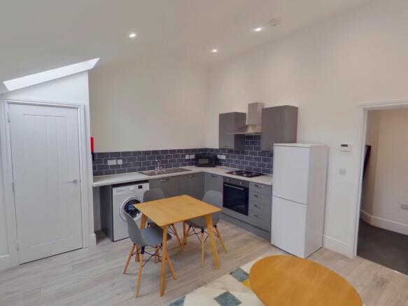 A modern and inviting kitchenette with ample na...