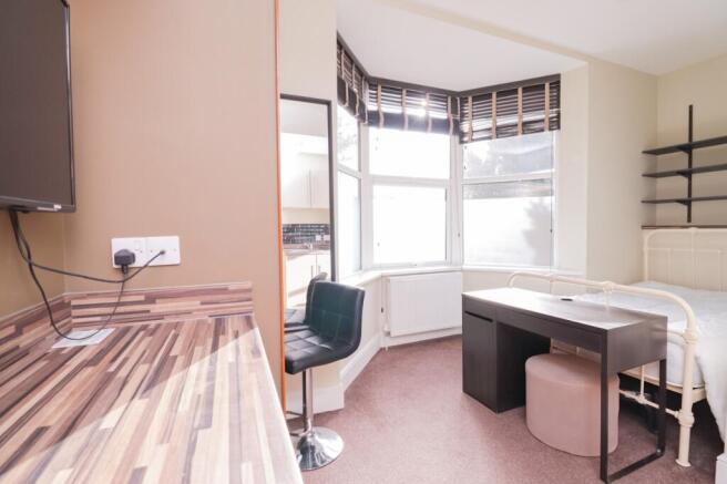 A bright and inviting double bedroom featuring ...