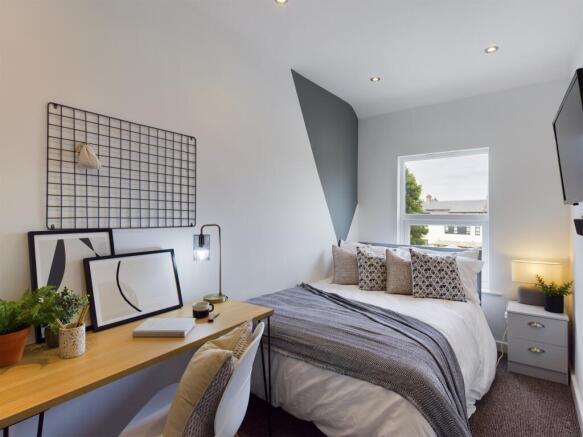 A stylish and inviting double bedroom featuring...