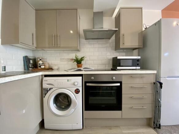 A modern and tidy kitchenette equipped with ess...