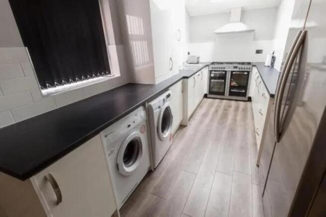 A spacious and modern kitchen featuring ample c...