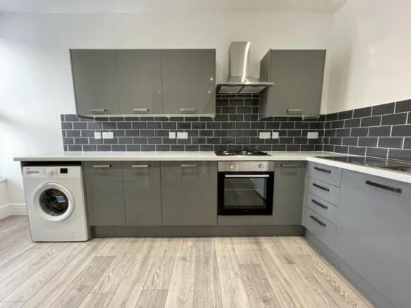 A modern and spacious kitchenette with sleek gr...