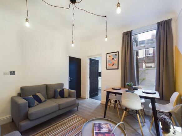 A stylish and spacious living room featuring mo...