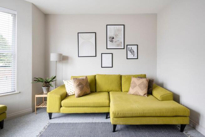 Bright, modern living room with a stylish chart...