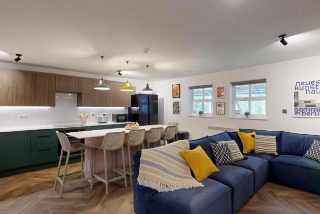 Bright, modern open-plan lounge with a deep blu...