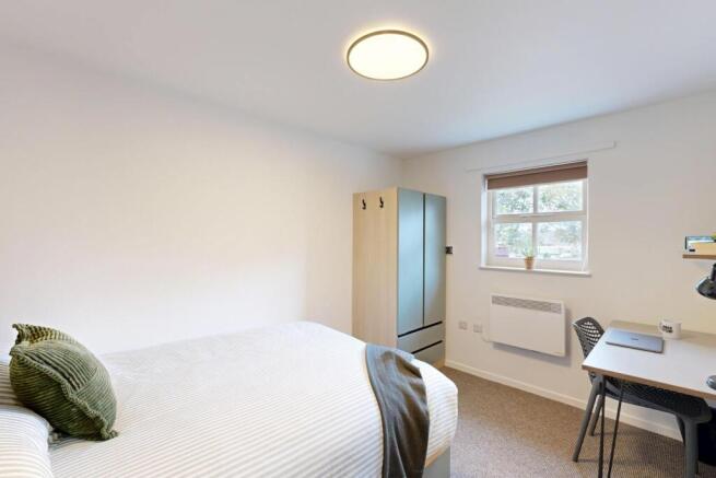 Bright, neatly presented bedroom with a comfort...