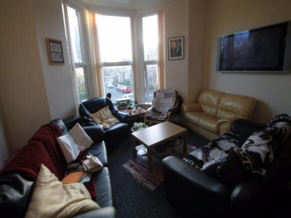 A cozy living room featuring a mix of comfortab...