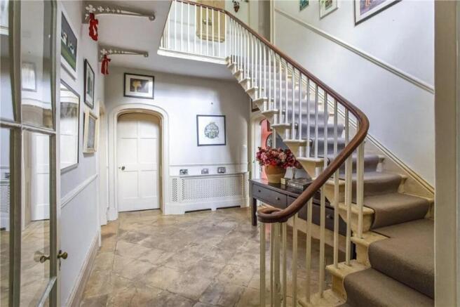 Welcoming hallway featuring elegant design elem...