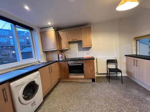 A spacious and well-maintained kitchen featurin...