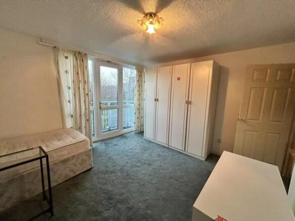 A bright double bedroom with a large wardrobe, ...
