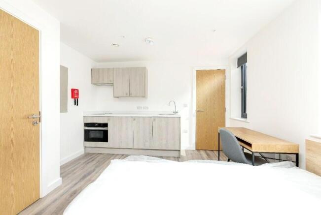 A bright and modern studio apartment featuring ...