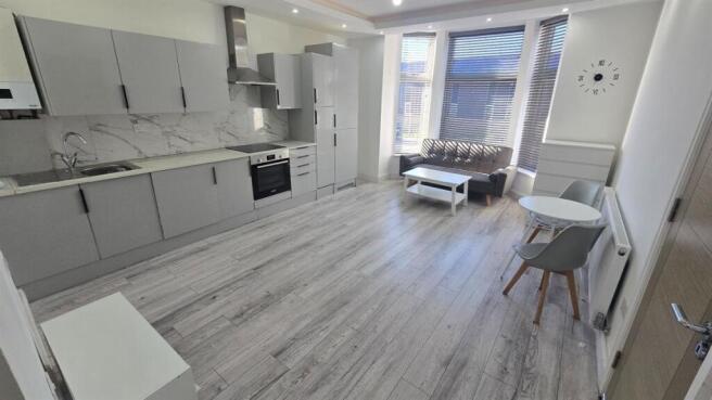 Bright and spacious living area with modern fur...