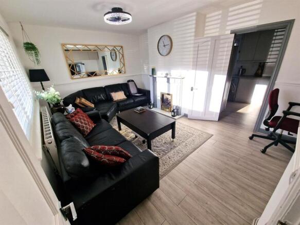 A bright and modern living room featuring a lar...