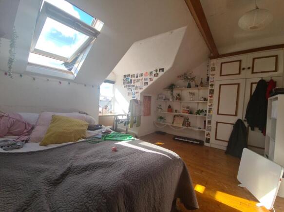 A bright and cozy master bedroom featuring a la...