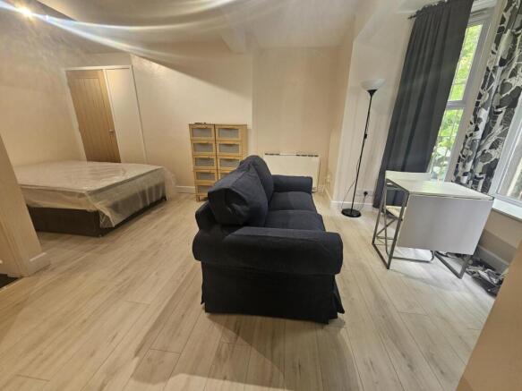 Spacious and well-lit bedroom featuring a comfo...