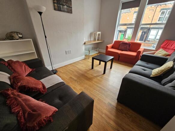 A spacious and welcoming living room featuring ...