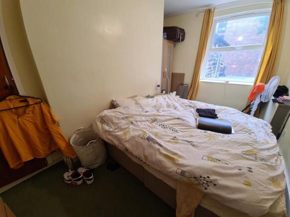 Cozy bedroom with a double bed positioned by a ...