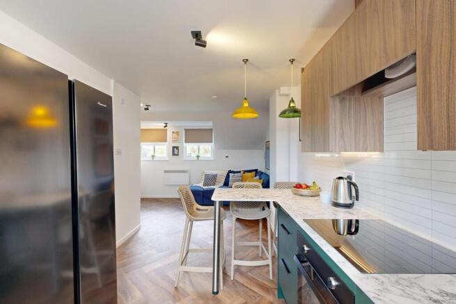 Modern open-plan kitchen with breakfast bar, in...