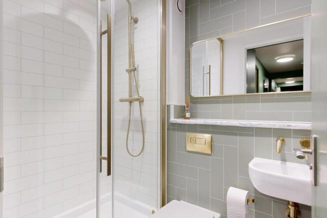 Modern tiled bathroom with a walk-in shower, wh...