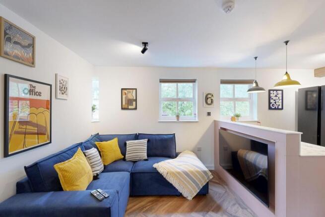 Bright, modern living room with a blue L-shaped...