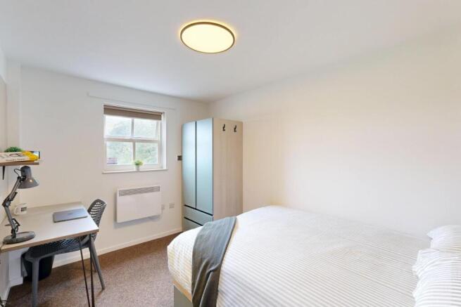 Bright, neatly presented bedroom with a comfort...
