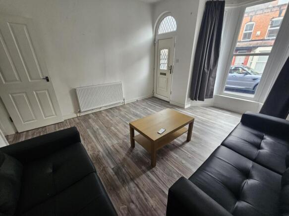 A bright and welcoming living room featuring la...