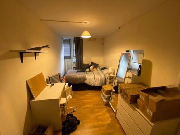 A cozy and well-organized double bedroom featur...