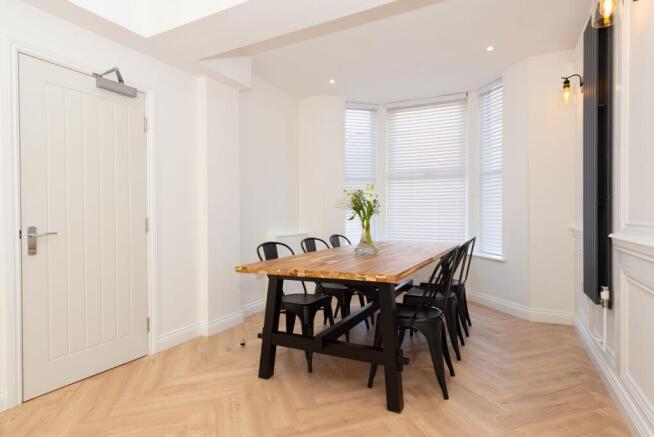 Bright, modern dining area with a large wooden ...