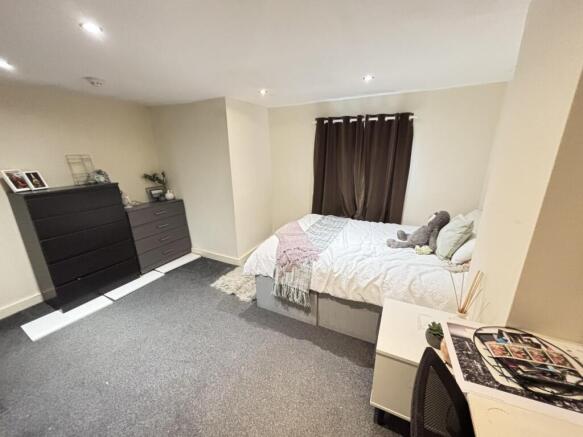 A spacious and well-maintained master bedroom f...