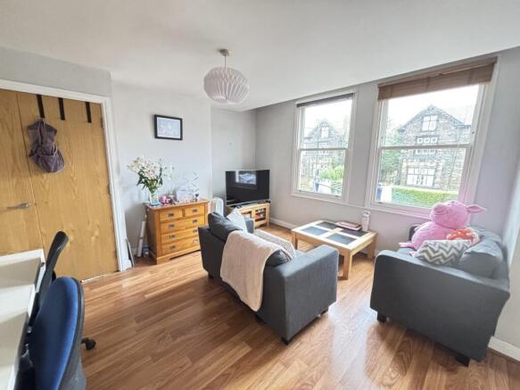 Bright and welcoming living room featuring ampl...