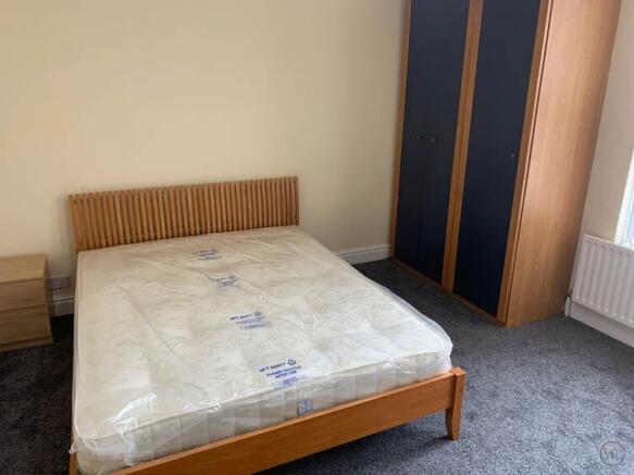 A spacious master bedroom with modern furnishin...