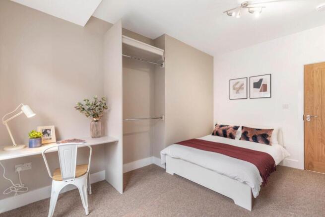 A spacious and well-maintained master bedroom f...