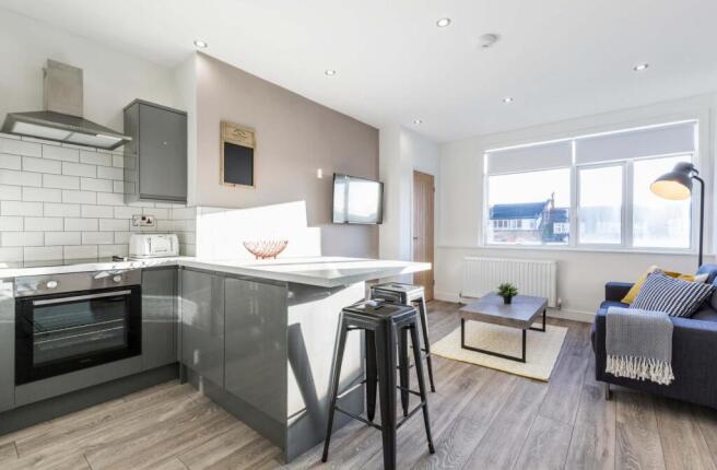 A bright, modern living room with ample natural...