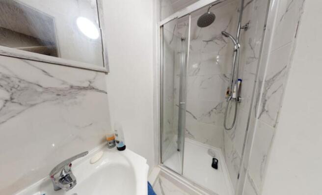 A modern bathroom featuring a large shower encl...