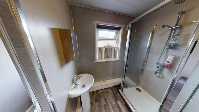 Bright and clean bathroom featuring a shower en...
