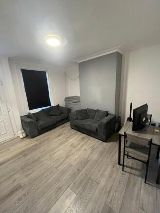 Bright and spacious living room featuring comfo...